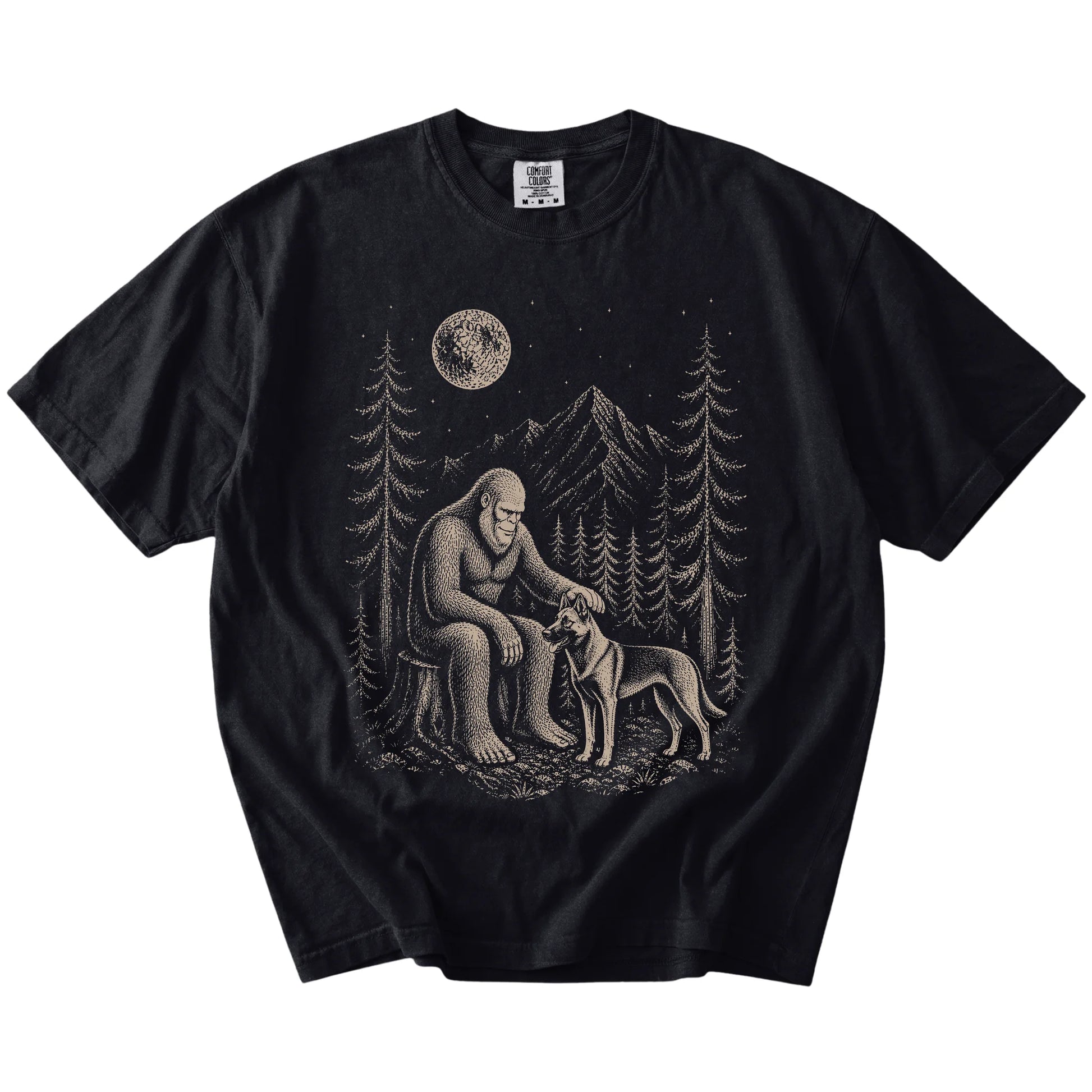 Bigfoot petting a Belgian Malinois beneath the moon in a pine forest on a Black Comfort Colors® T-shirt