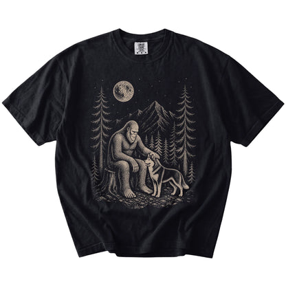 Bigfoot petting a Husky beneath the moon in a pine forest on a Black Comfort Colors® T-shirt