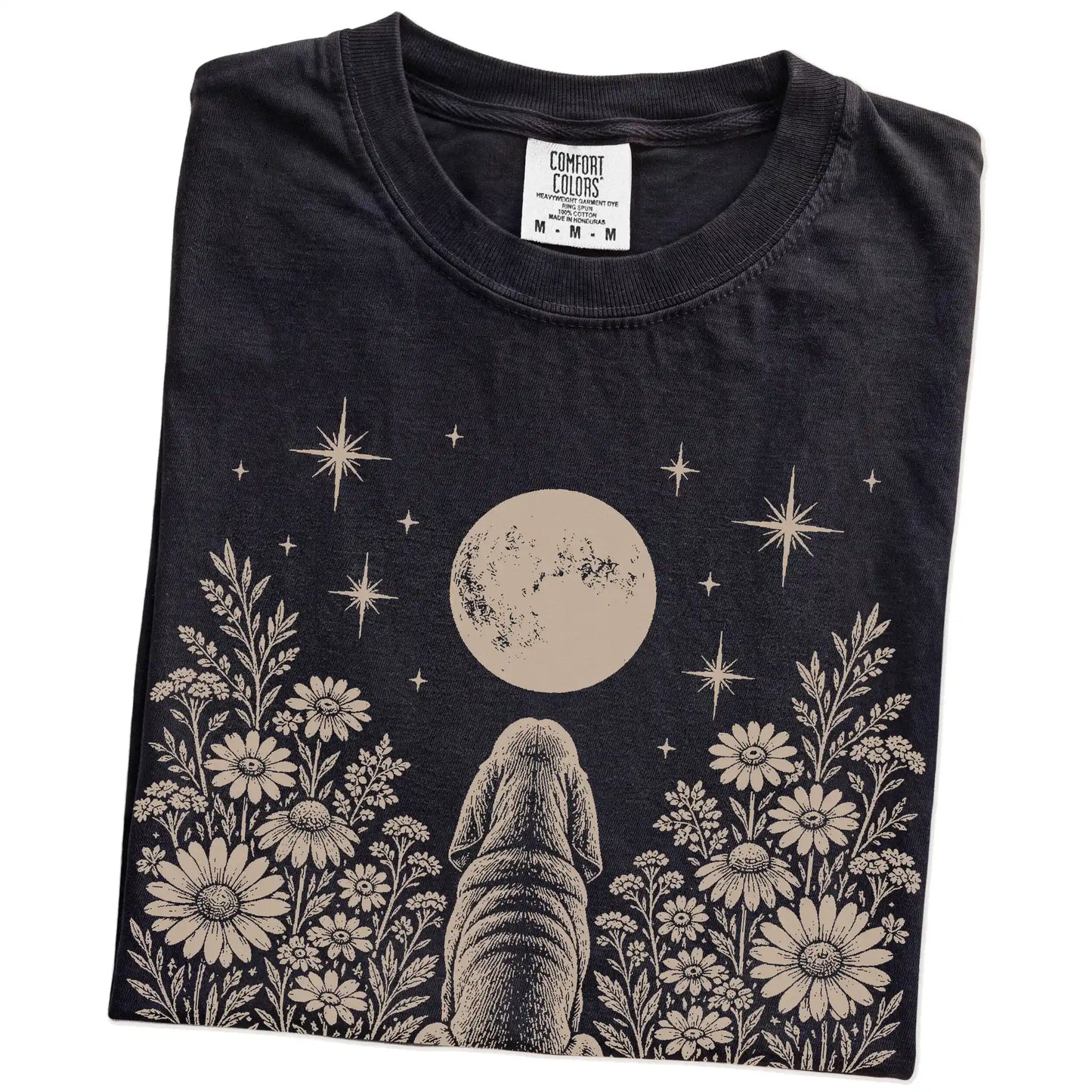 Folded Black Comfort Colors® T-shirt showing Bloodhound beneath a wildflower moon