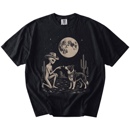 Cowboy alien fist-bumping a Border Collie beneath the moon on a Black Comfort Colors® T-shirt