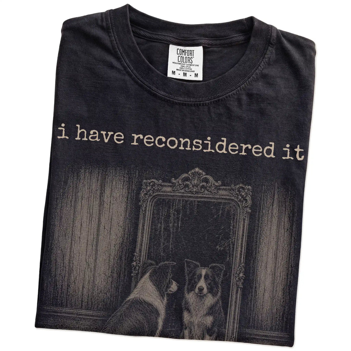 Folded Black Comfort Colors® T-shirt showing “the answer is still no” border collie design