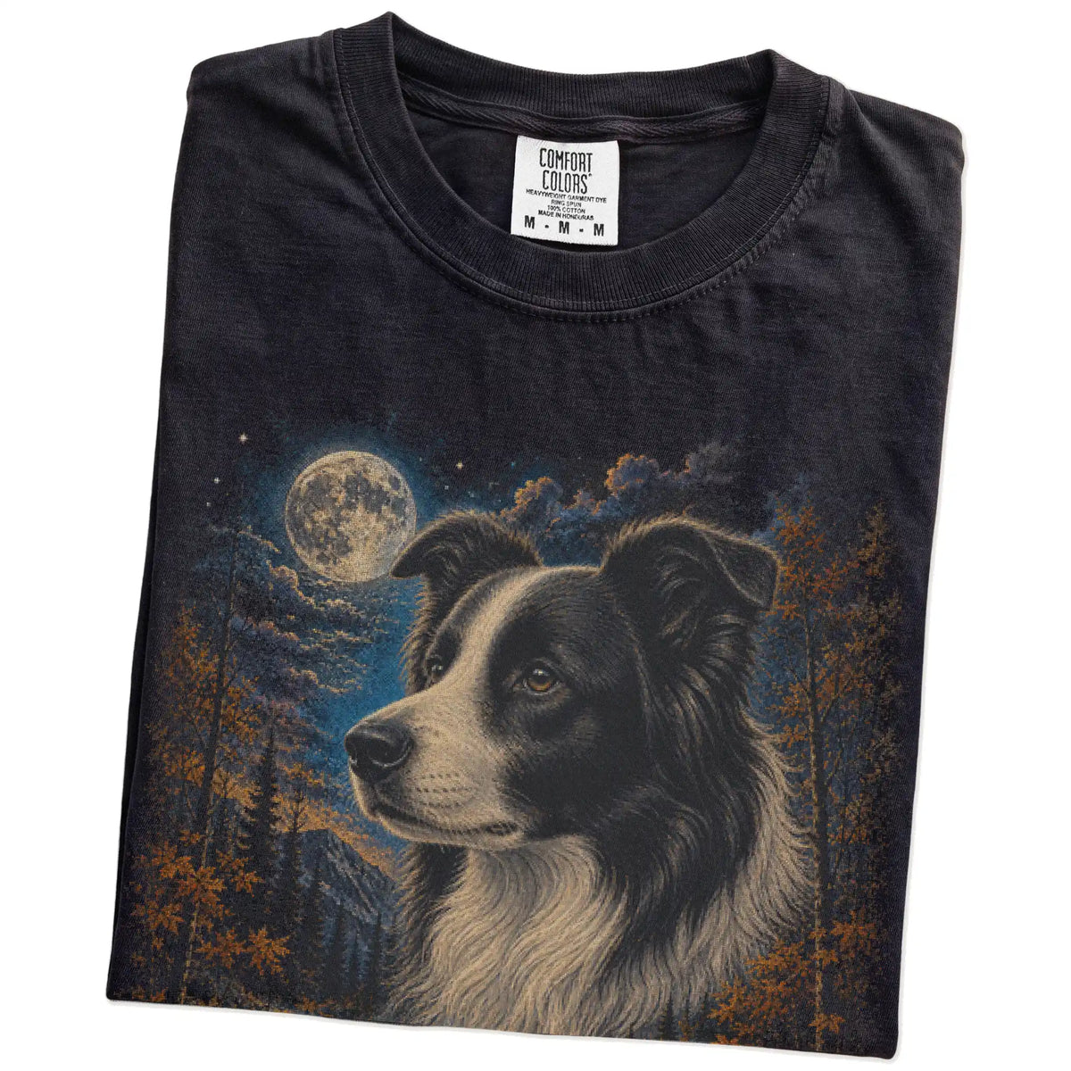 Folded Black Comfort Colors® t-shirt showing Border Collie in a fall forest graphic