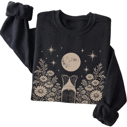 Black crewneck sweatshirt featuring Wildflower Moon Border Collie, folded presentation