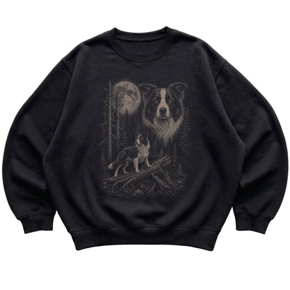 Border Collie Moonlit Forest graphic on a black crewneck sweatshirt laid flat