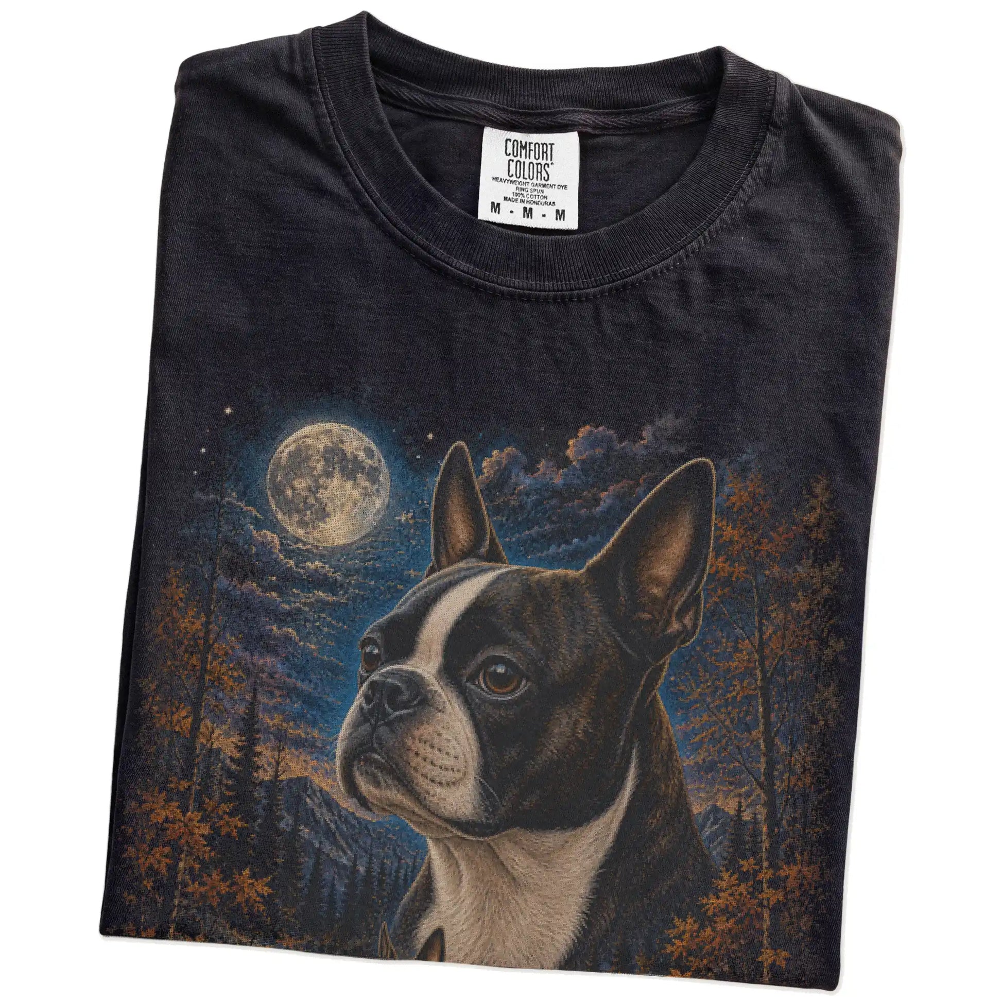 Folded Black Comfort Colors® t-shirt showing Boston Terrier in a fall forest graphic
