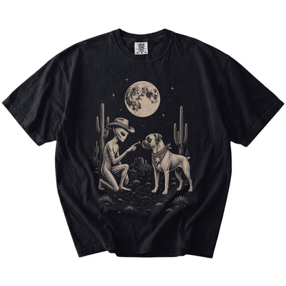 Cowboy alien fist-bumping a Boxer beneath the moon on a Black Comfort Colors® T-shirt