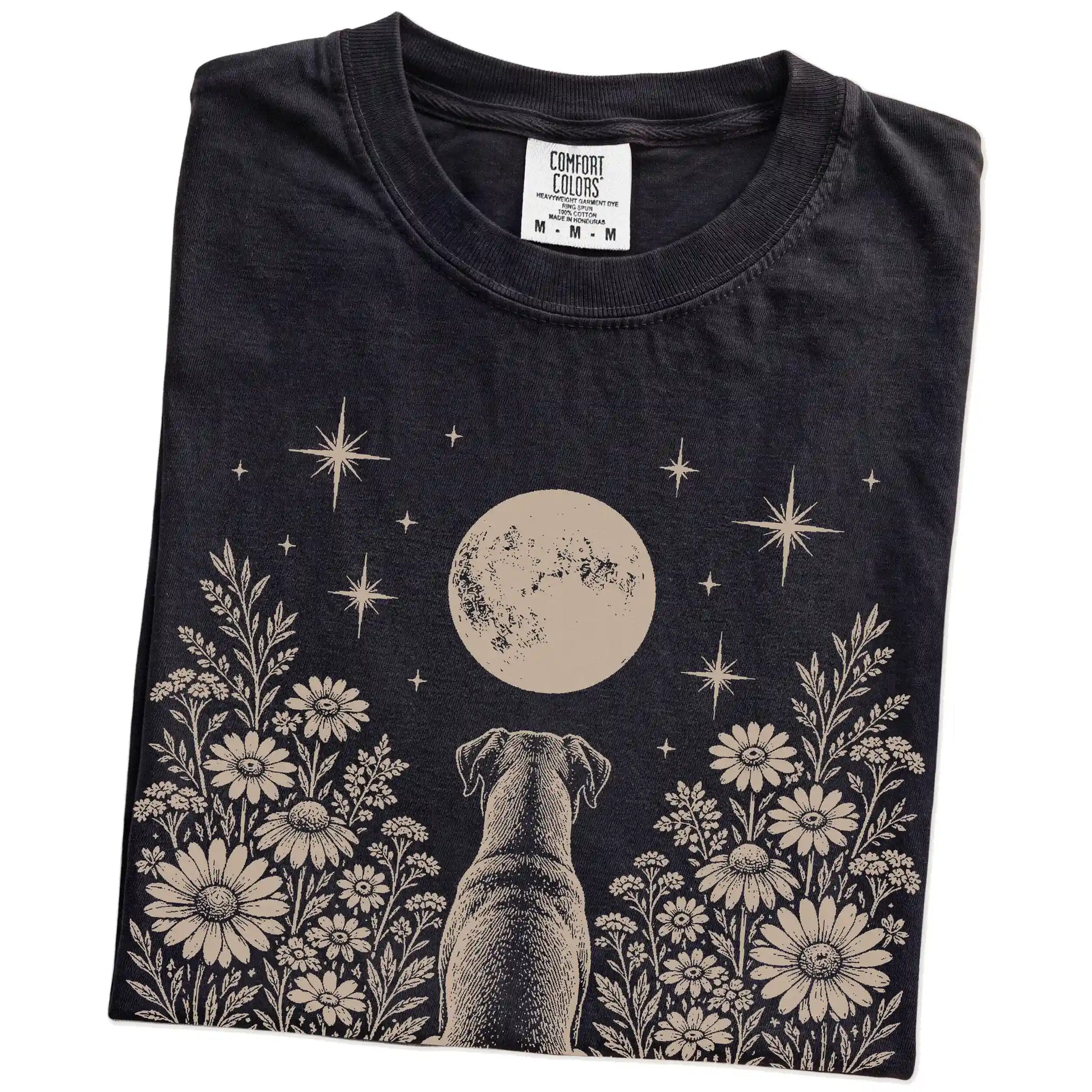 Folded Black Comfort Colors® T-shirt showing Boxer beneath a wildflower moon