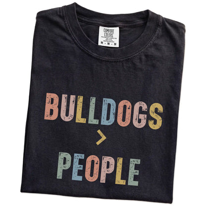 Folded Black Comfort Colors® T-shirt showing “Bulldogs > People” text