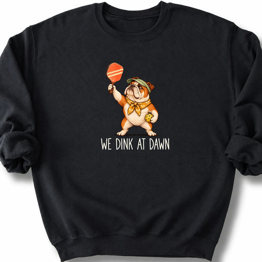 Bulldog with a pickleball paddle and ball on a Black Gildan® sweatshirt with We Dink at Dawn text