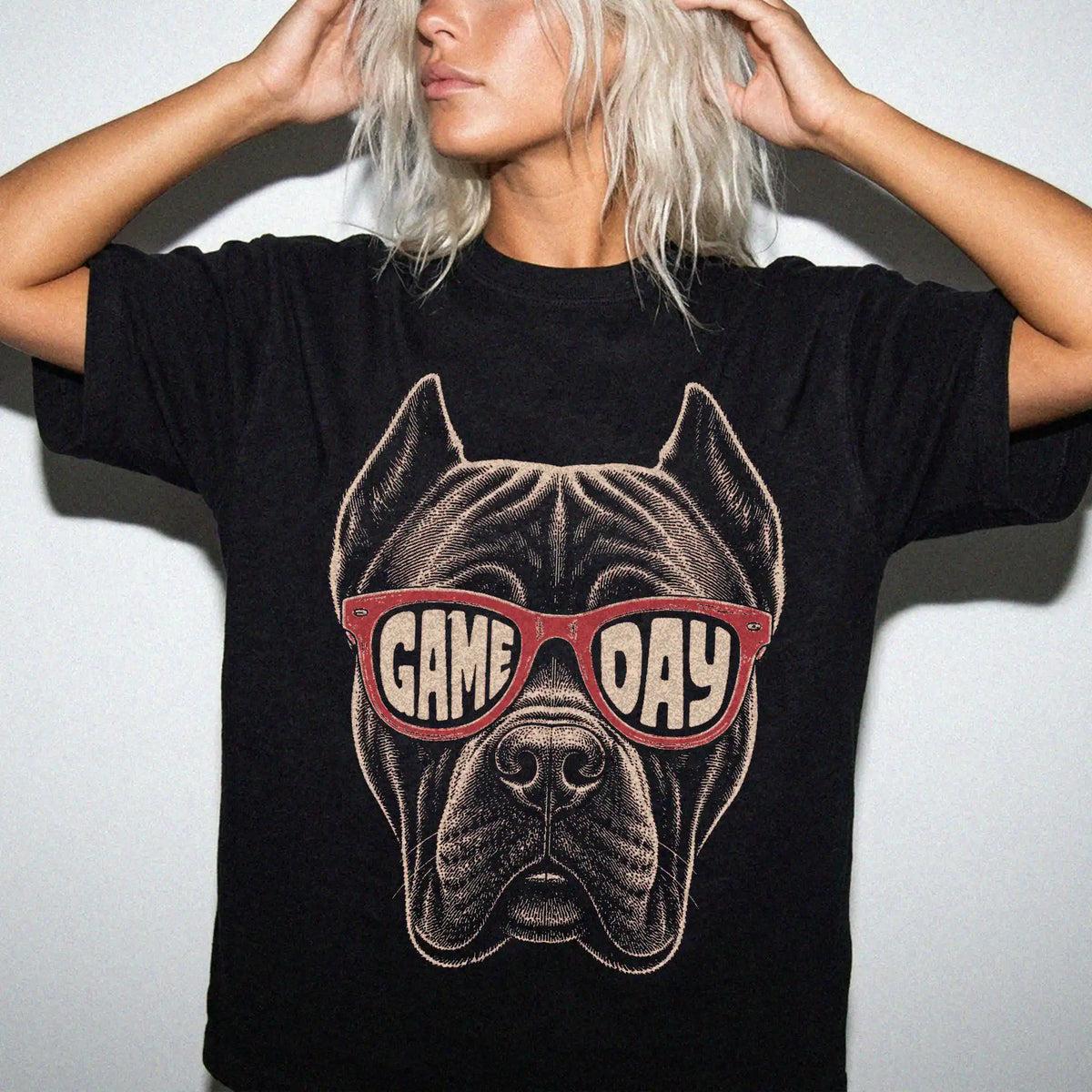 Model wearing a Black Comfort Colors® T-shirt with cane corso wearing red game day sunglasses