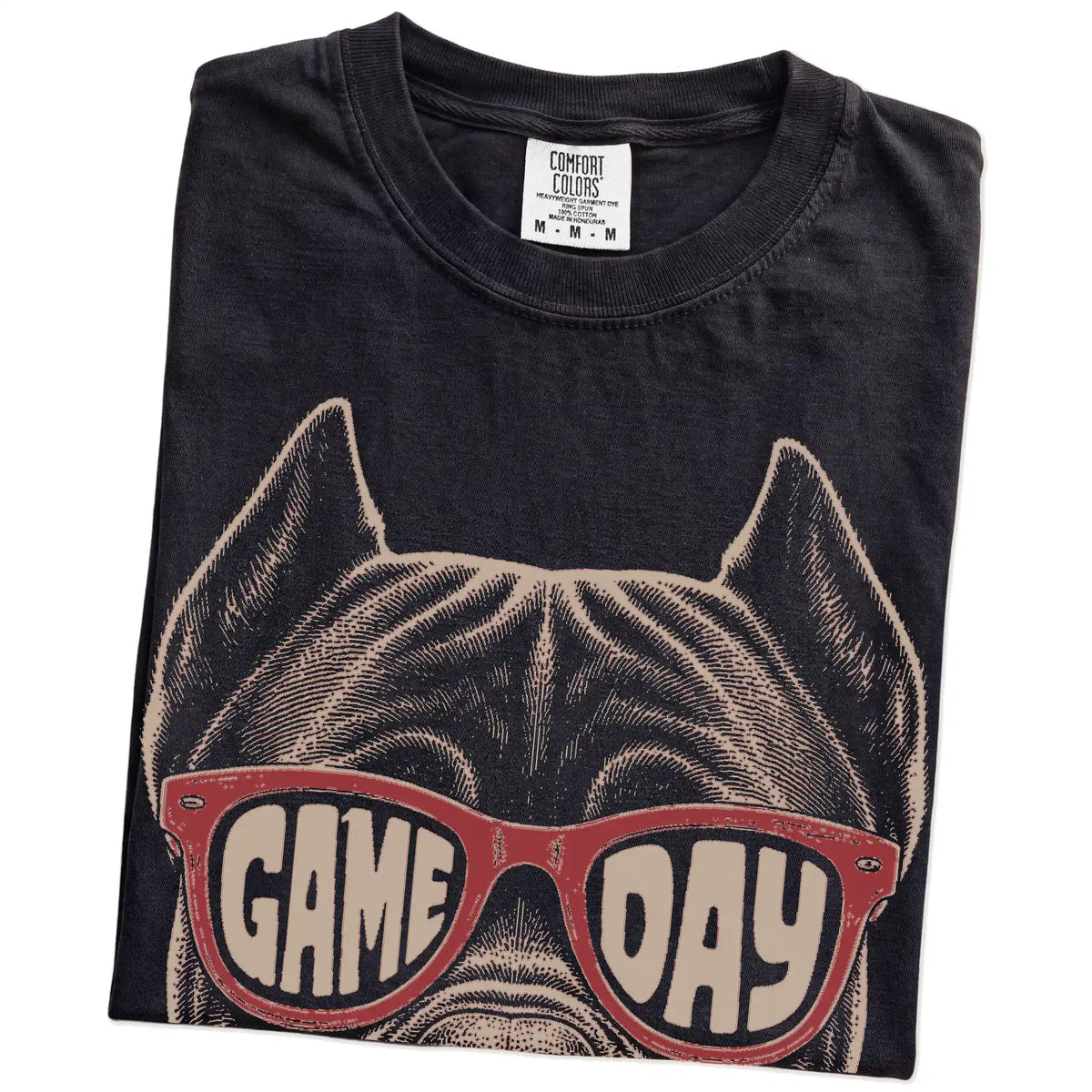 Folded Black Comfort Colors® T-shirt showing cane corso wearing red game day sunglasses