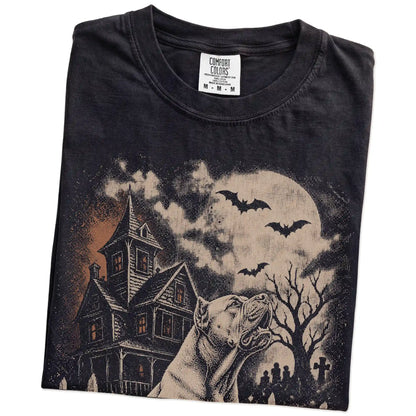 Folded Black Comfort Colors® T-shirt showing Cane Corso in a vintage haunted-house scene