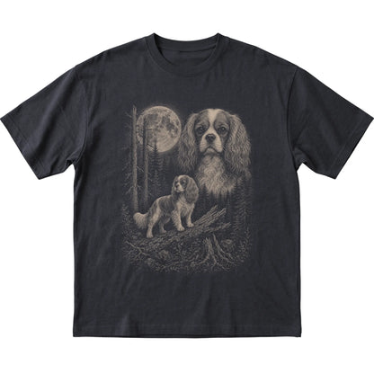 Cavalier King Charles Spaniel Moonlit Forest graphic on a black Softstyle T-shirt laid flat