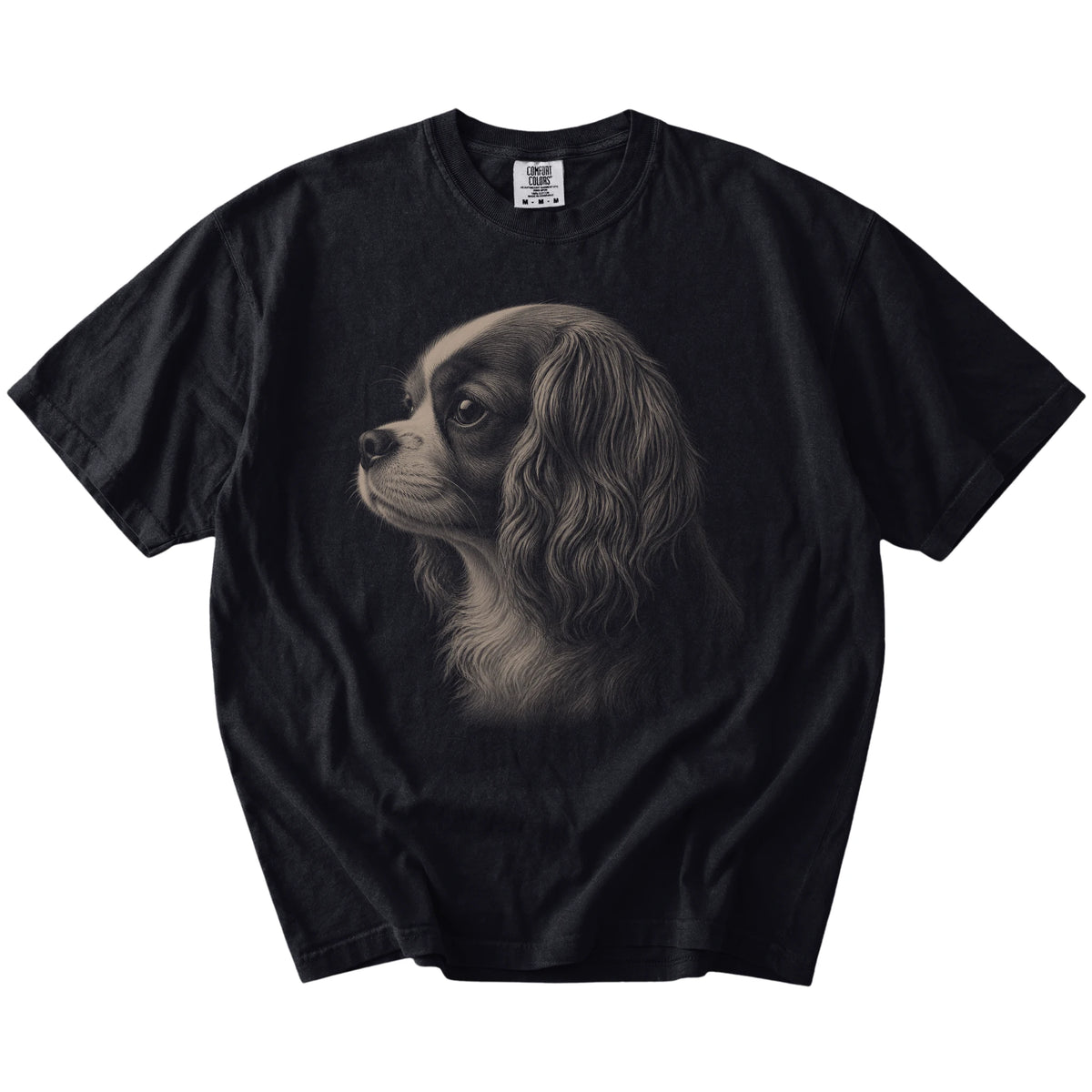 A detailed photographic portrait of a Cavalier King Charles Spaniel on a Black Comfort Colors® T-shirt