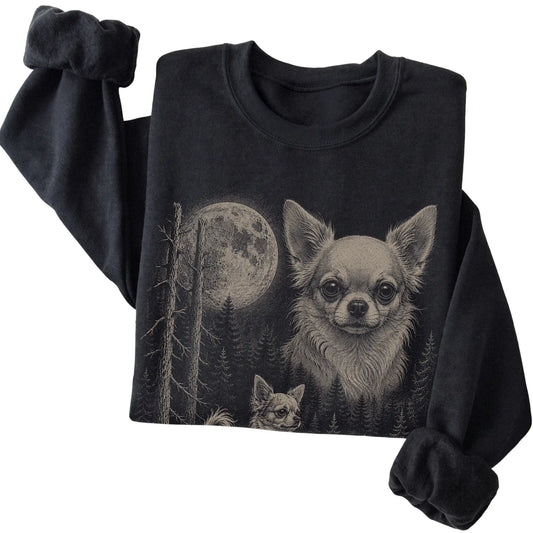 Folded black crewneck sweatshirt showing the Chihuahua Moonlit Forest graphic
