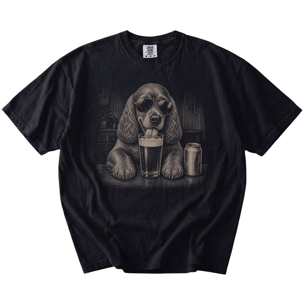 Cocker Spaniel sneaking a drink from a foamy pint at home on a Black Comfort Colors® t-shirt