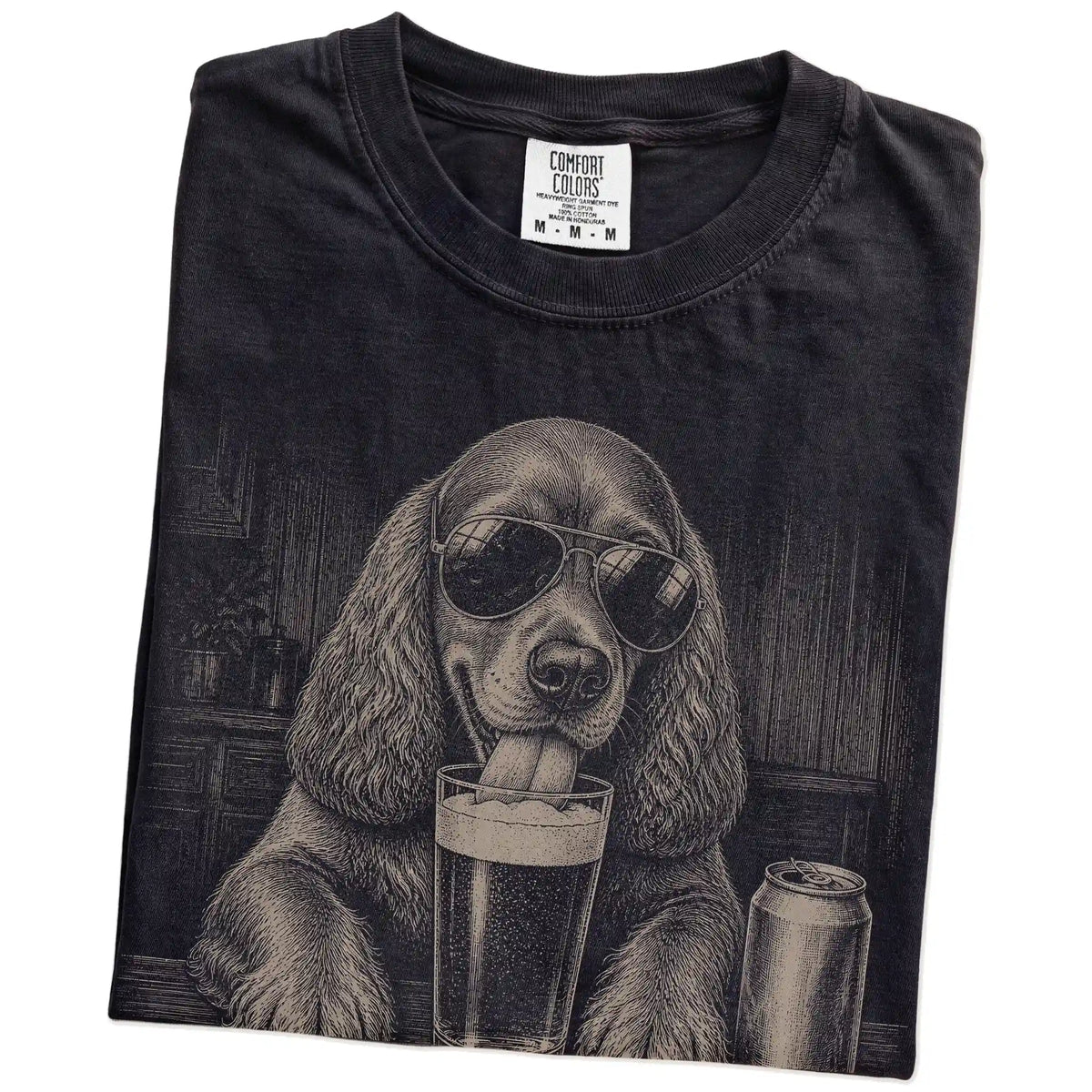 Folded Black Comfort Colors® t-shirt showing Cocker Spaniel sneaking a drink from a pint