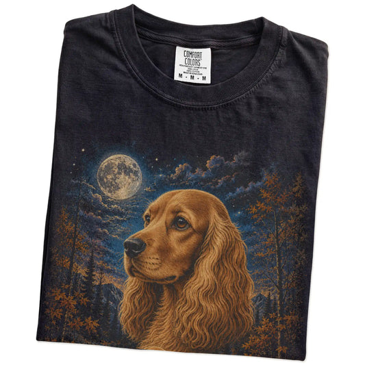 Folded Black Comfort Colors® t-shirt showing Cocker Spaniel in a fall forest graphic