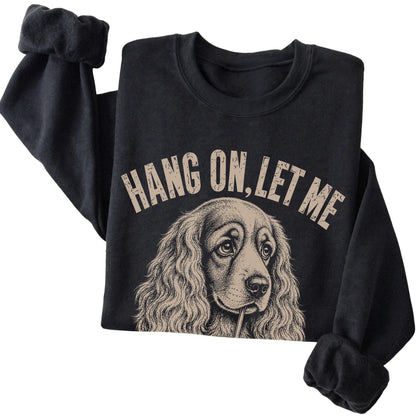 Black crewneck sweatshirt featuring Overthinking Cocker Spaniel, folded presentation