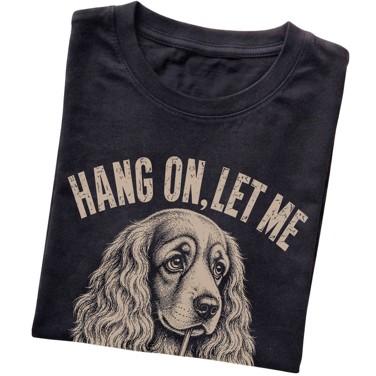 Black T-shirt featuring Overthinking Cocker Spaniel, folded presentation