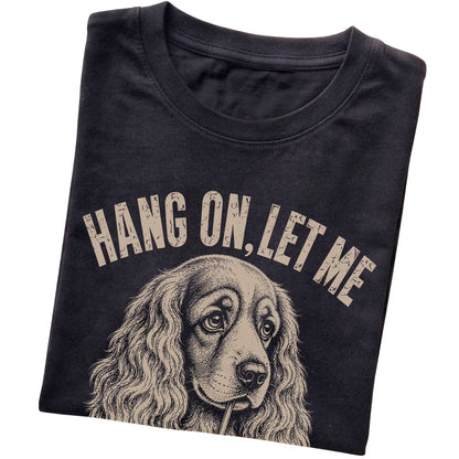 Black T-shirt featuring Overthinking Cocker Spaniel, folded presentation