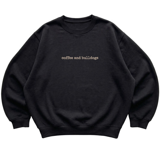 Black Coffee and Bulldogs sweatshirt laid flat