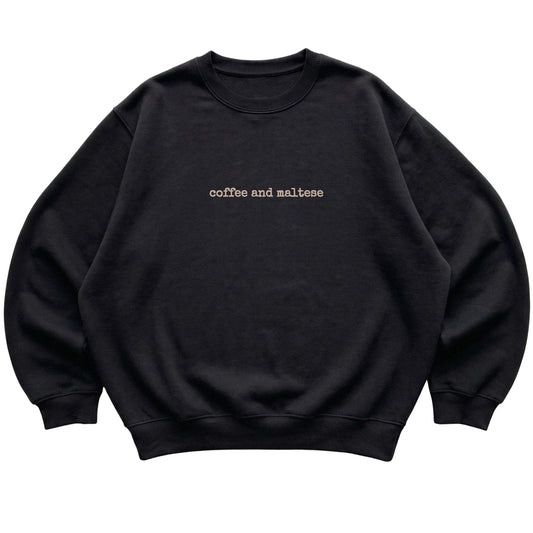 Black Coffee and Maltese sweatshirt laid flat