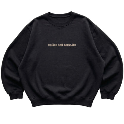 Black Coffee and Mastiffs sweatshirt laid flat