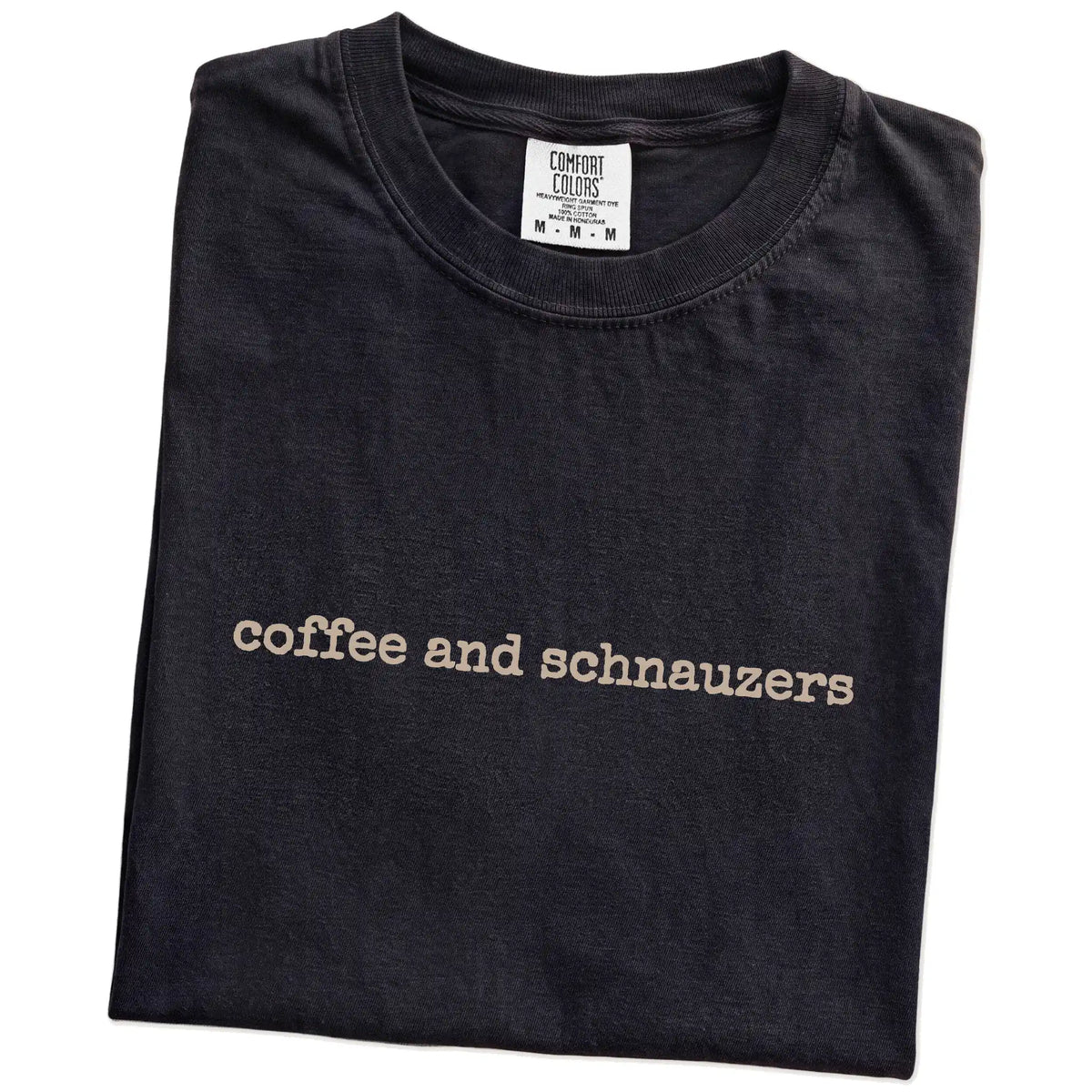 Folded Black Comfort Colors® T-shirt showing “coffee and schnauzers” retro text