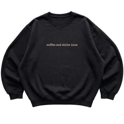 Black Coffee and Shiba Inus sweatshirt laid flat