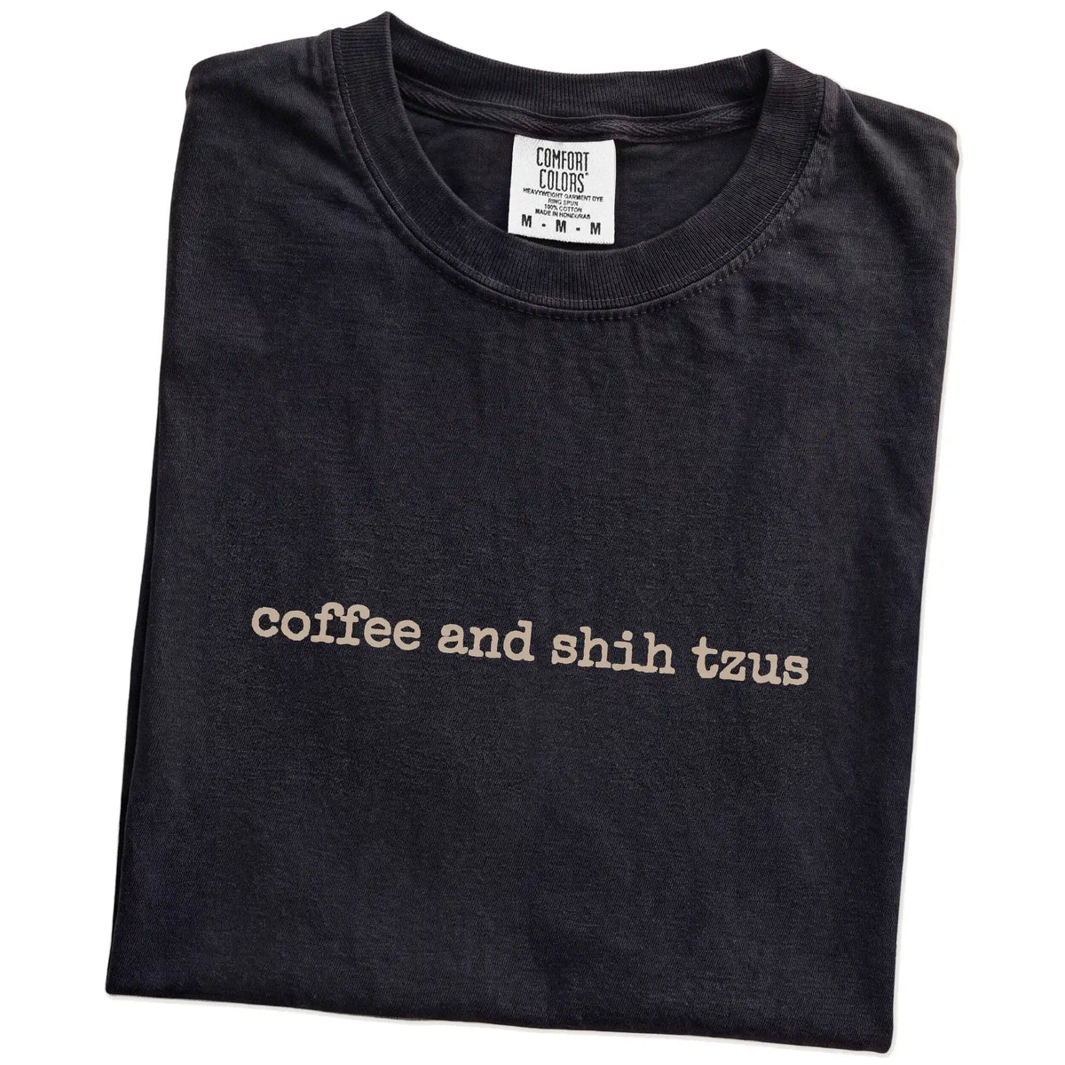Folded Black Comfort Colors® T-shirt showing “coffee and shih tzus” retro text