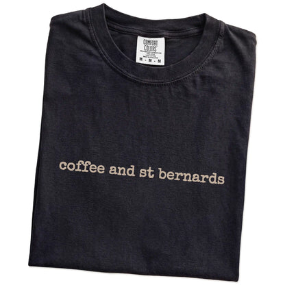 Folded Black Comfort Colors® T-shirt showing “coffee and st bernards” retro text