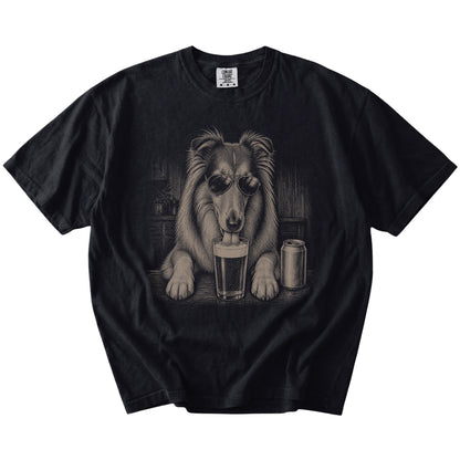 Collie sneaking a drink from a foamy pint at home on a Black Comfort Colors® t-shirt