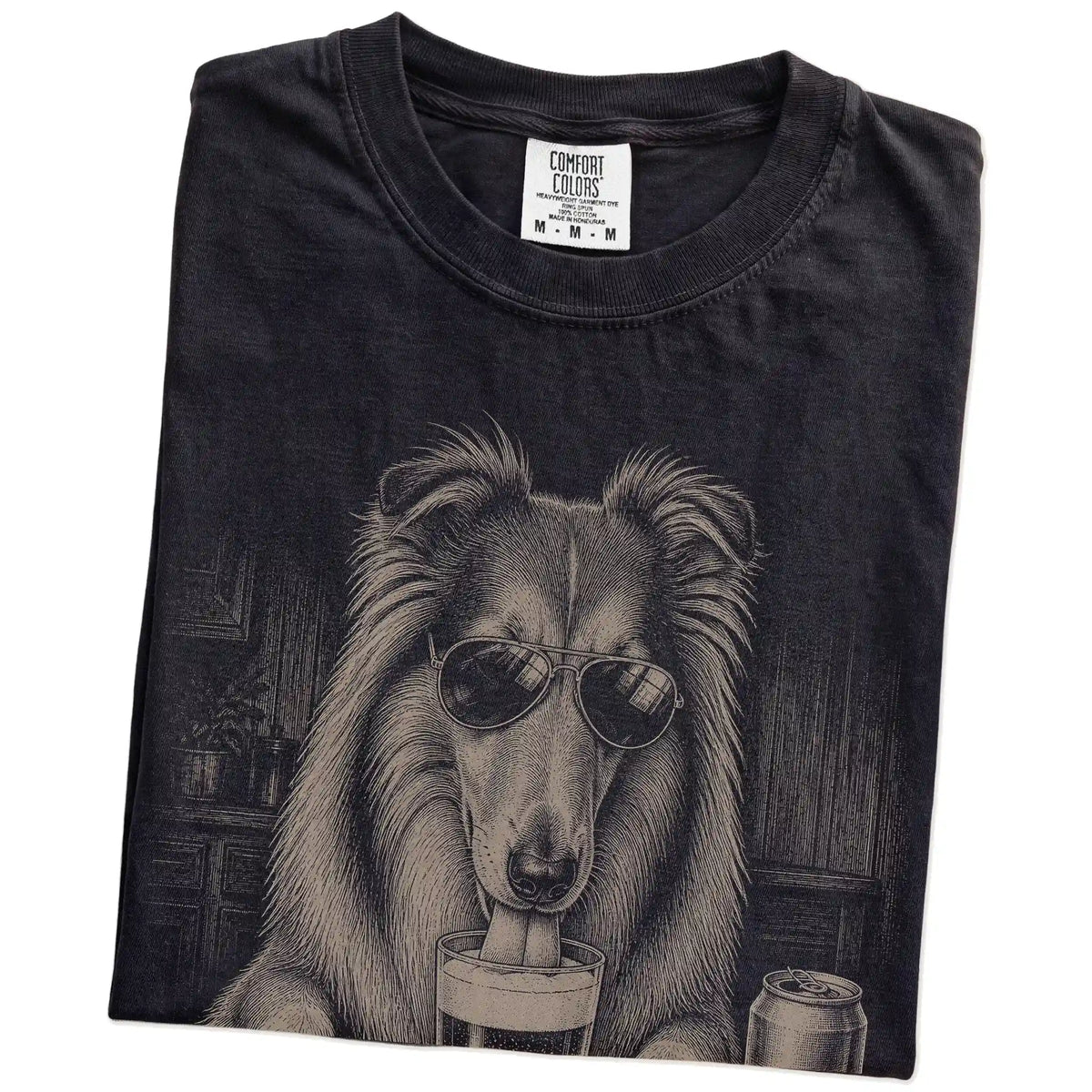 Folded Black Comfort Colors® t-shirt showing Collie sneaking a drink from a pint