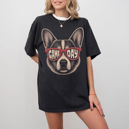 Model wearing a Black Comfort Colors® T-shirt with corgi wearing red game day sunglasses