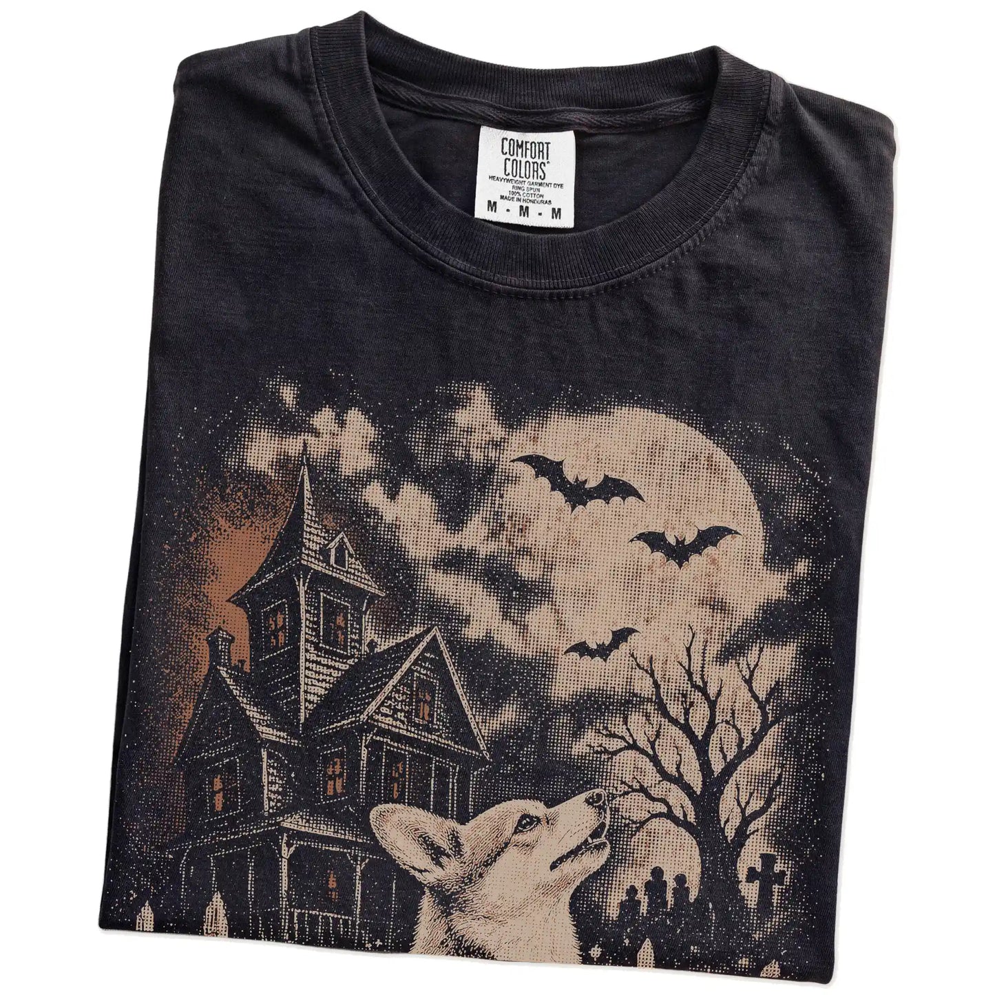 Folded Black Comfort Colors® T-shirt showing Corgi in a vintage haunted-house scene