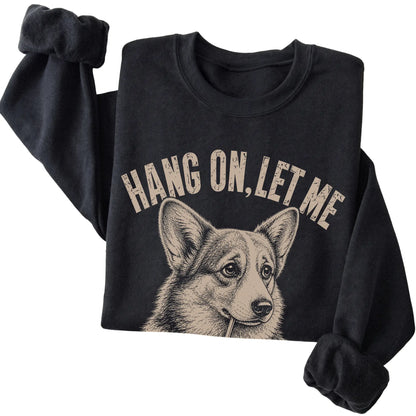 Black crewneck sweatshirt featuring Overthinking Corgi, folded presentation