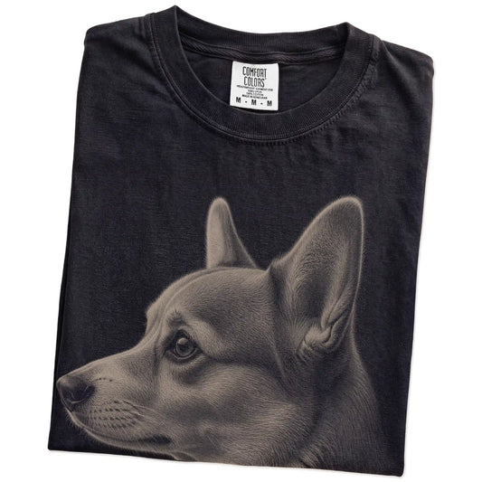 Folded Black Comfort Colors® T-shirt showing a detailed photographic portrait of a Corgi