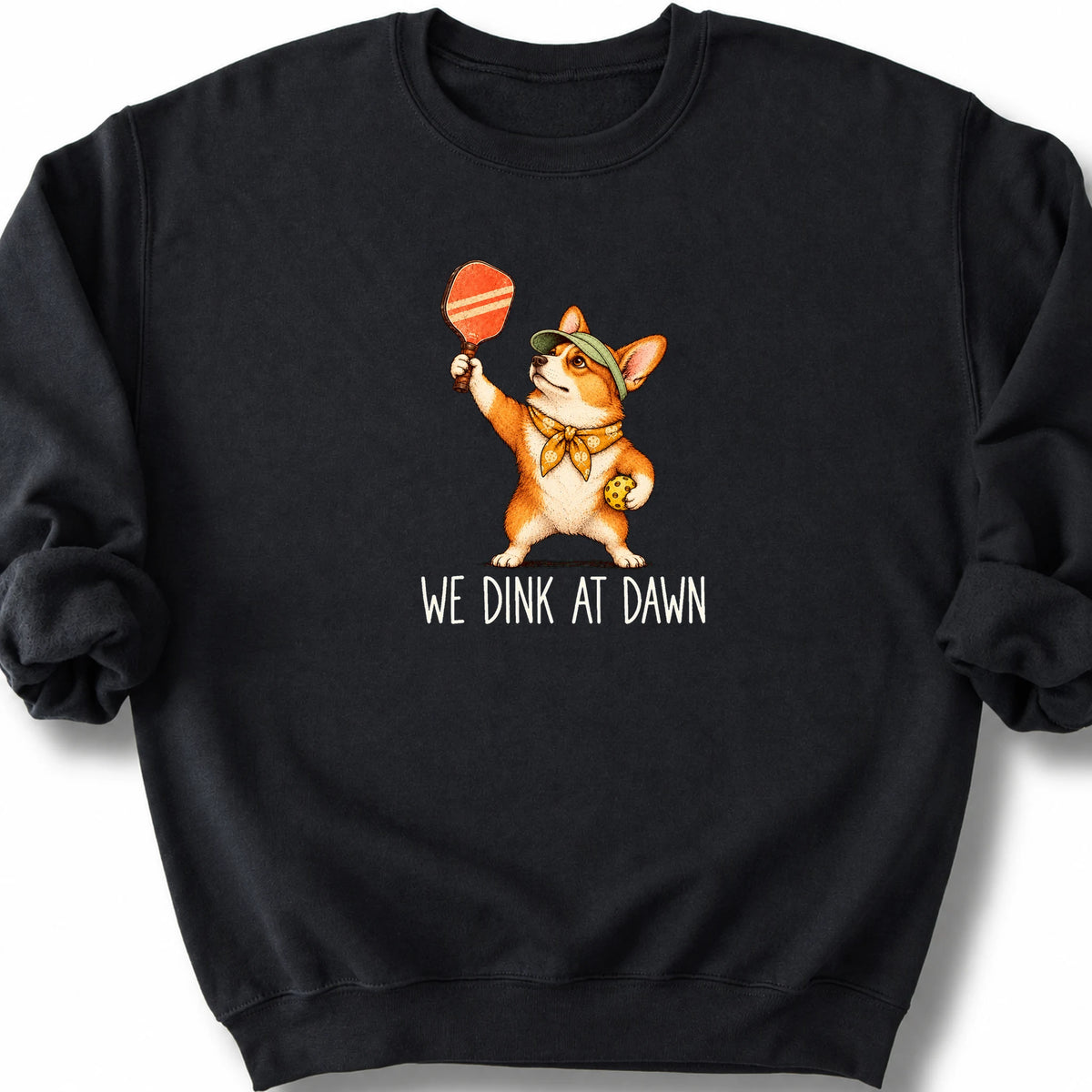 Corgi with a pickleball paddle and ball on a Black Gildan® sweatshirt with We Dink at Dawn text