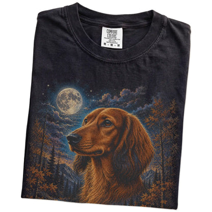 Folded black T-shirt with Dachshund Autumn Moon artwork.