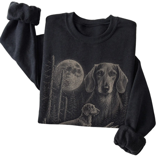 Folded black crewneck sweatshirt showing the Dachshund Moonlit Forest graphic