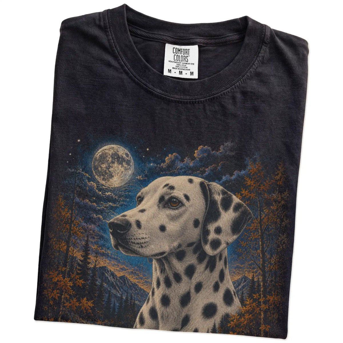 Folded Black Comfort Colors® t-shirt showing Dalmatian in a fall forest graphic