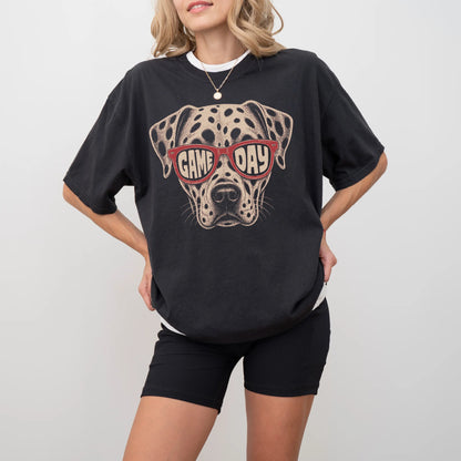 Model wearing a Black Comfort Colors® T-shirt with dalmatian wearing red game day sunglasses