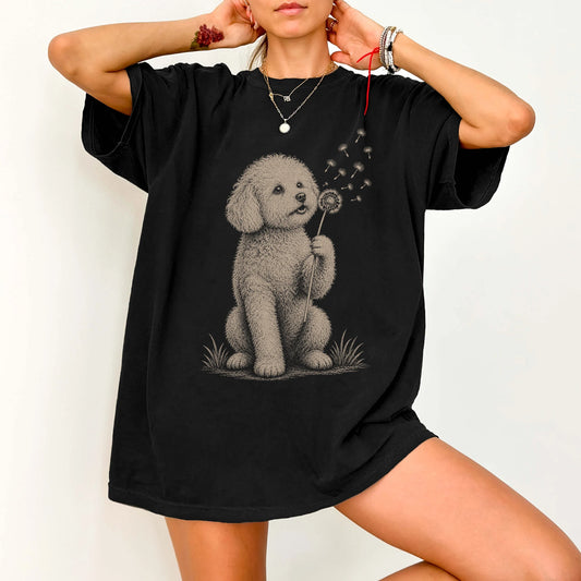 Model wearing a Black Comfort Colors® T-shirt showing Bichon Frise portrait with drifting dandelion seeds