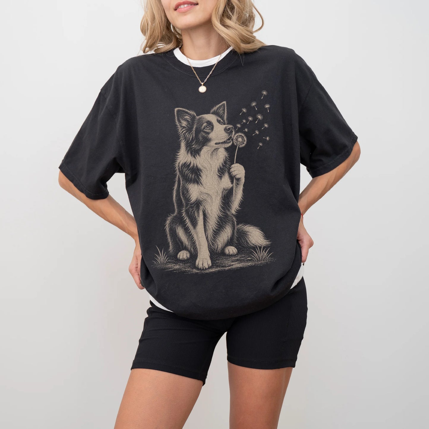 Model wearing a Black Comfort Colors® T-shirt showing Border Collie portrait with drifting dandelion seeds