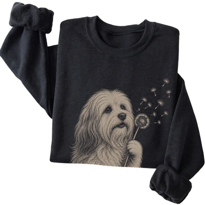 Black crewneck sweatshirt featuring Dandelion Havanese, folded presentation