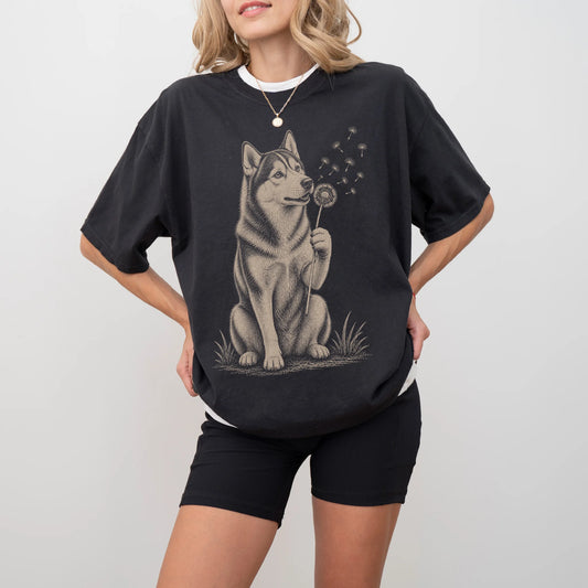 Model wearing a Black Comfort Colors® T-shirt showing Husky portrait with drifting dandelion seeds