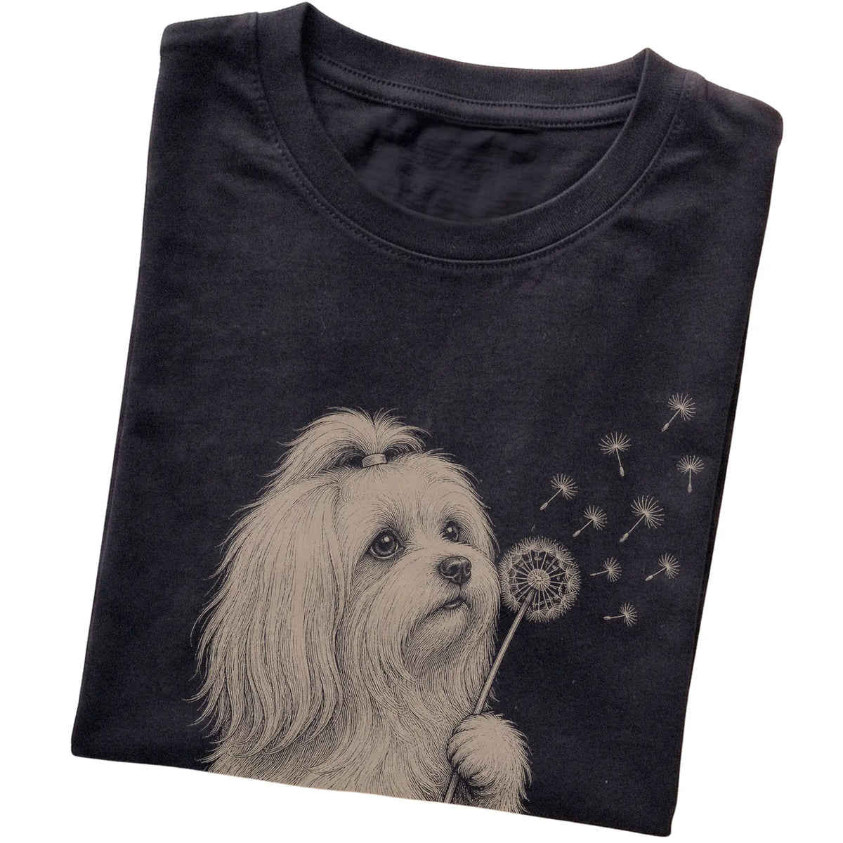 Black T-shirt featuring Dandelion Maltese, folded presentation