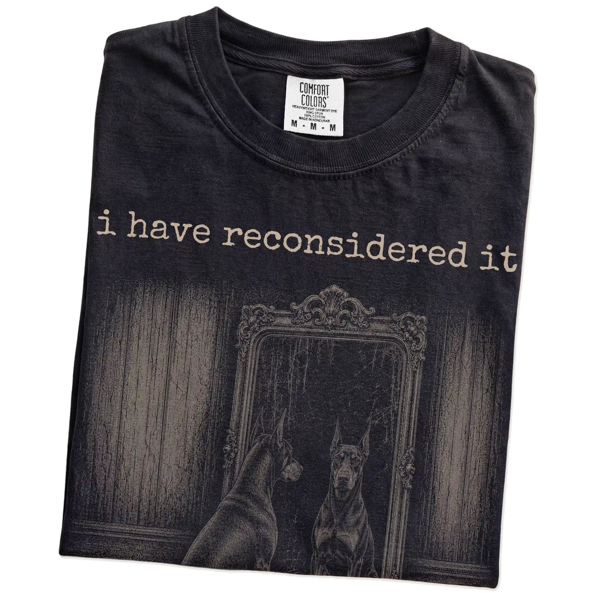 Folded Black Comfort Colors® T-shirt showing “the answer is still no” doberman design