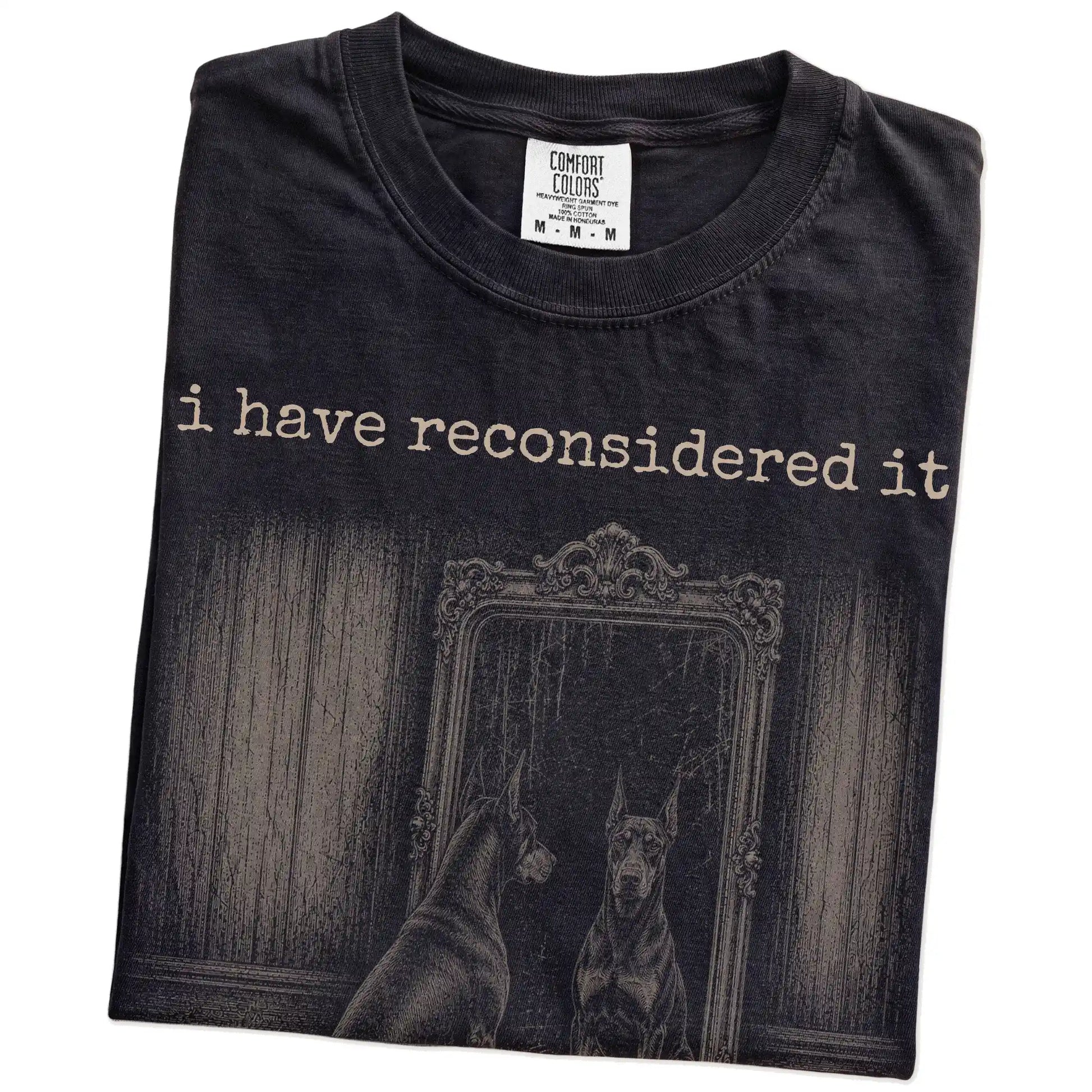 Folded Black Comfort Colors® T-shirt showing “the answer is still no” doberman design